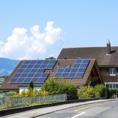 Weggis, Switzerland - August 22, 2018: Solar Panel Photovoltaic installation on a Roof (alternative electricity source) in Weggis, Switzerland. Solar (PV-PhotoVoltaic) panels are the power systems created by the serial and parallel connection of solar cells that convert the solar energy directly into DC electric energy.