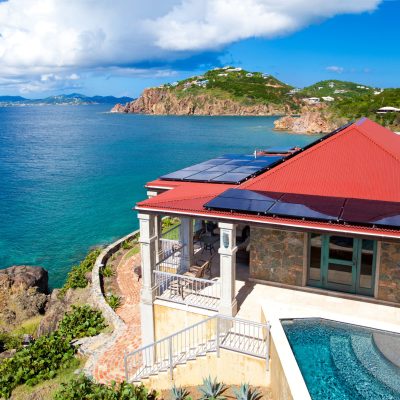 luxury Caribbean villa with alternative energy photovoltaic solar panels on roof