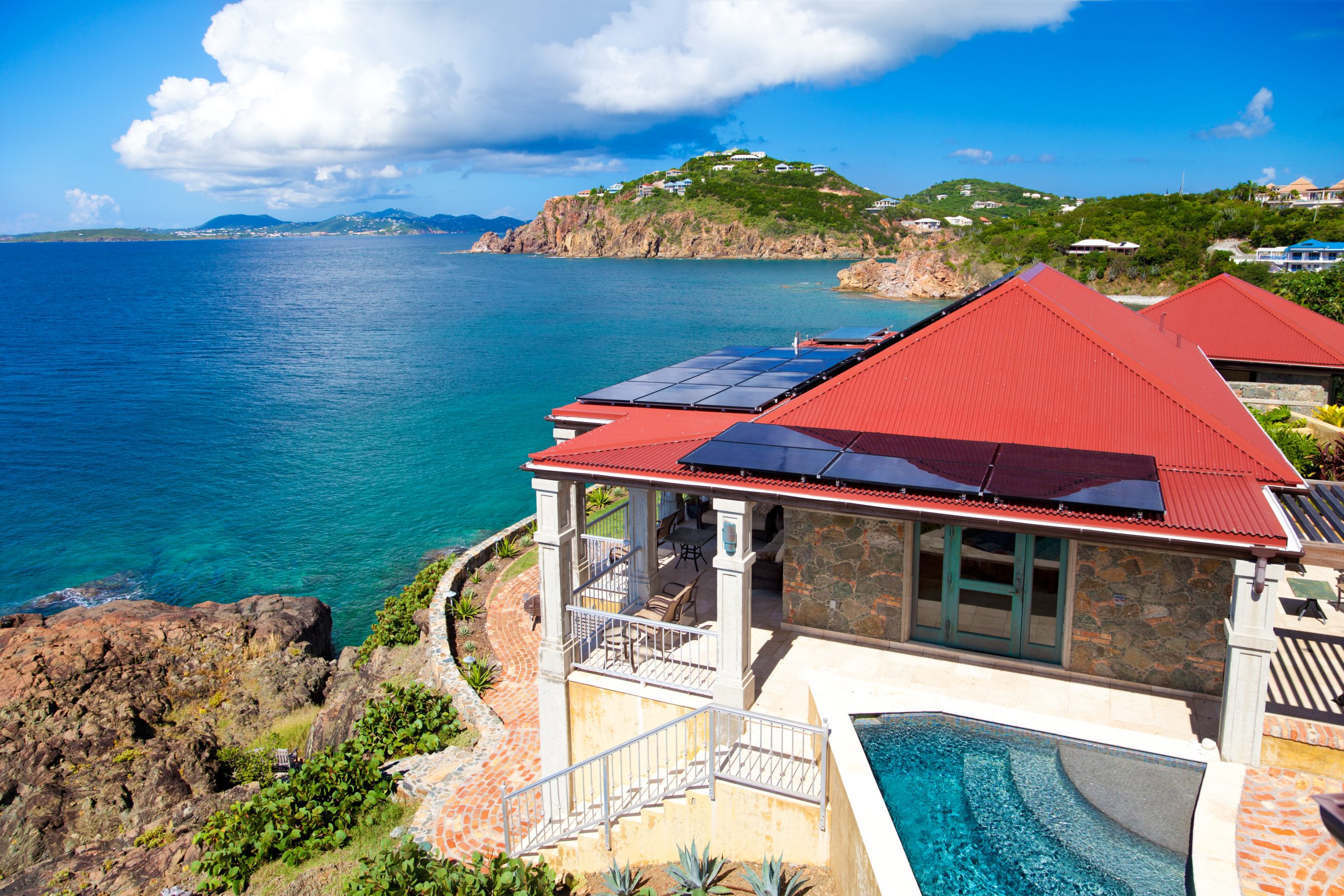 luxury Caribbean villa with alternative energy photovoltaic solar panels on roof